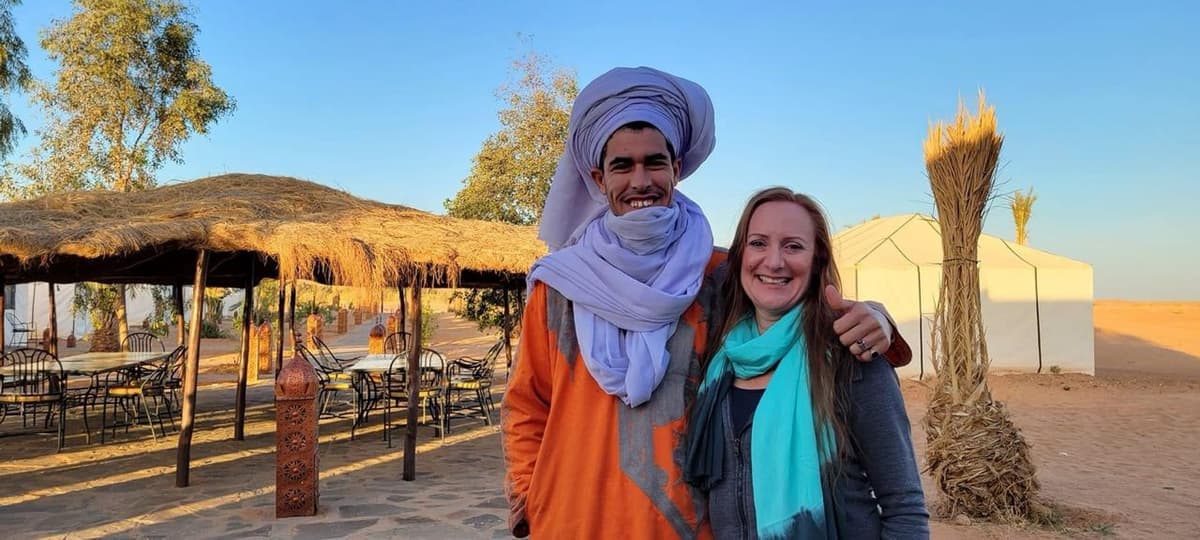 Travelers exploring the Moroccan desert with a local guide