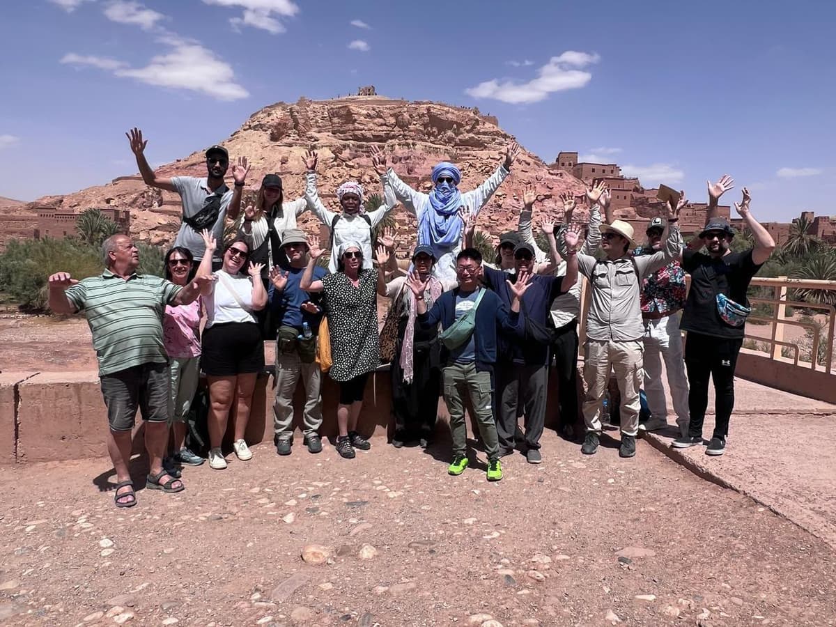 Friends enjoying a shared group tour in Morocco at sunset
